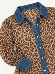 Leopard blouse collar, denim trim and button detail, laid flat